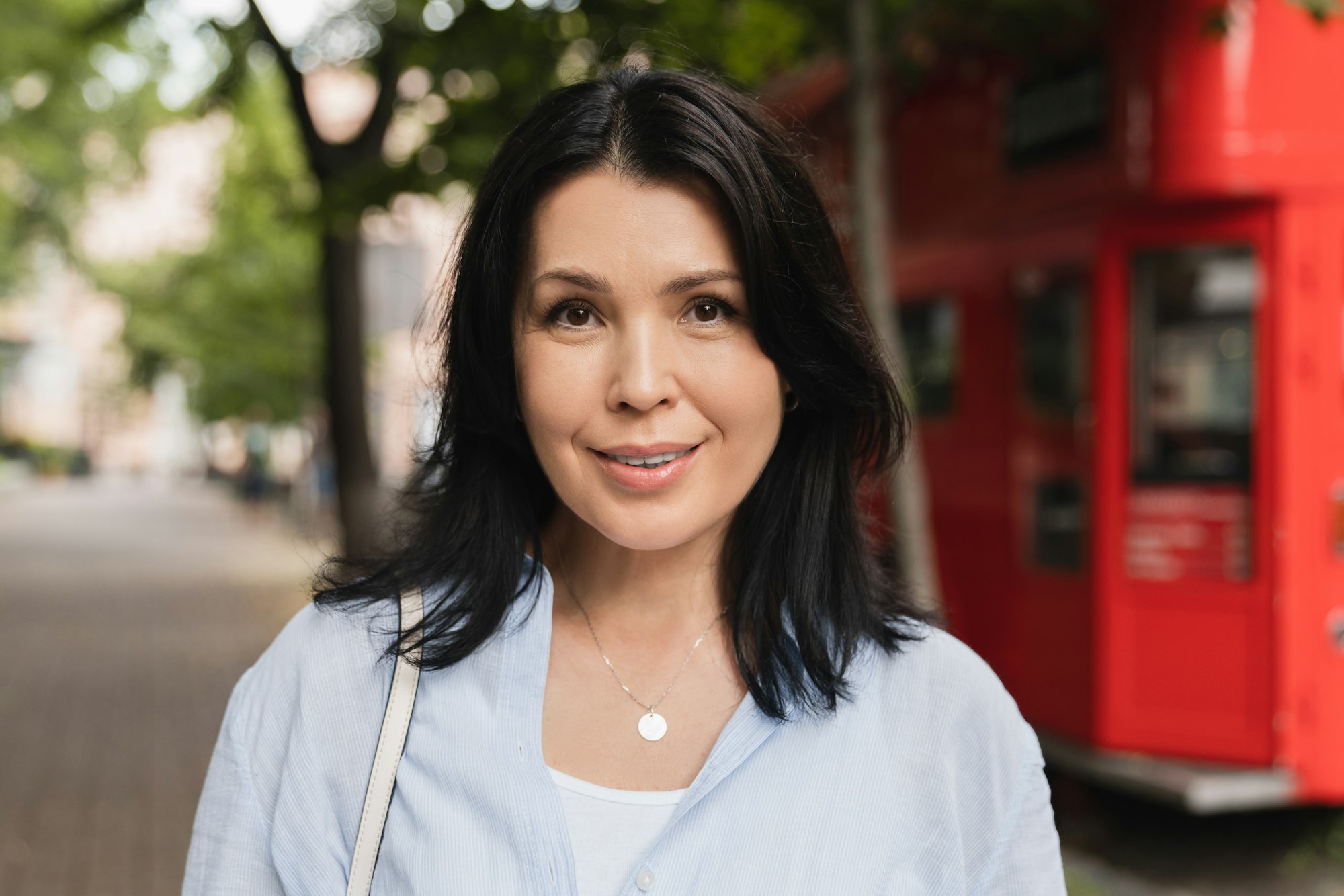 Confident beautiful caucasian mature woman looking at the camera and smiling