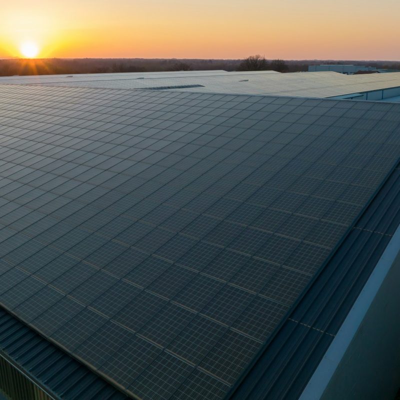 Blue photovoltaic solar panels mounted on building roof