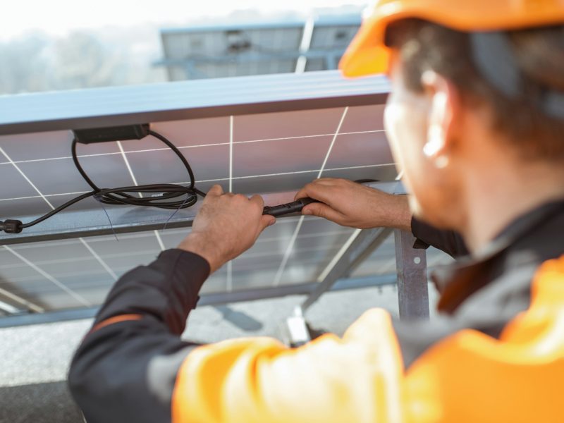 Electrician connecting solar panels