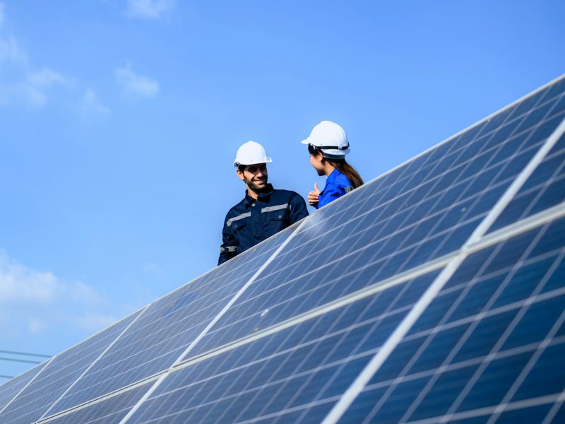 Solar panel station, Engineer installing solar panel at solar energy farm field