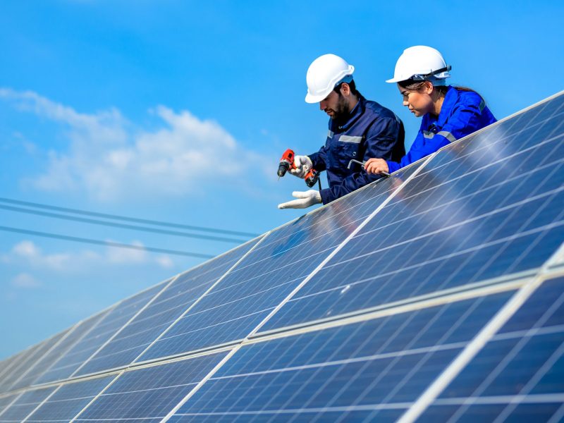 Solar panel station, Engineer installing solar panel at solar energy farm field